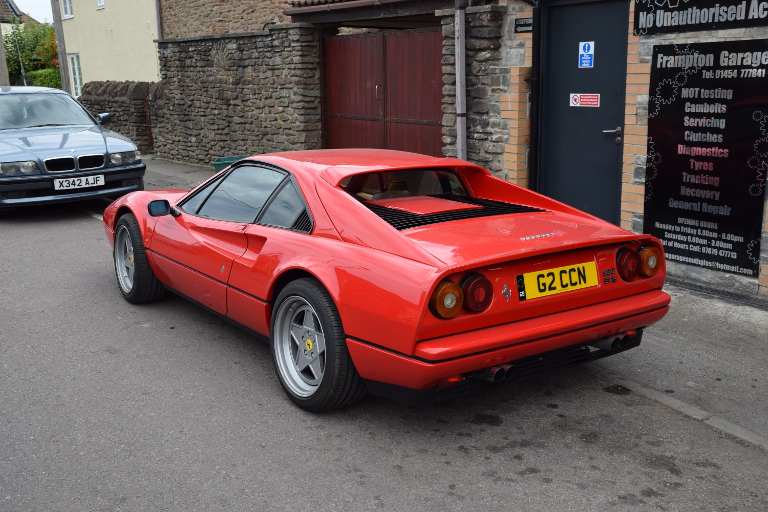 Rear and side view of a classic sports coupe with distinctive tail lights and rear vents.