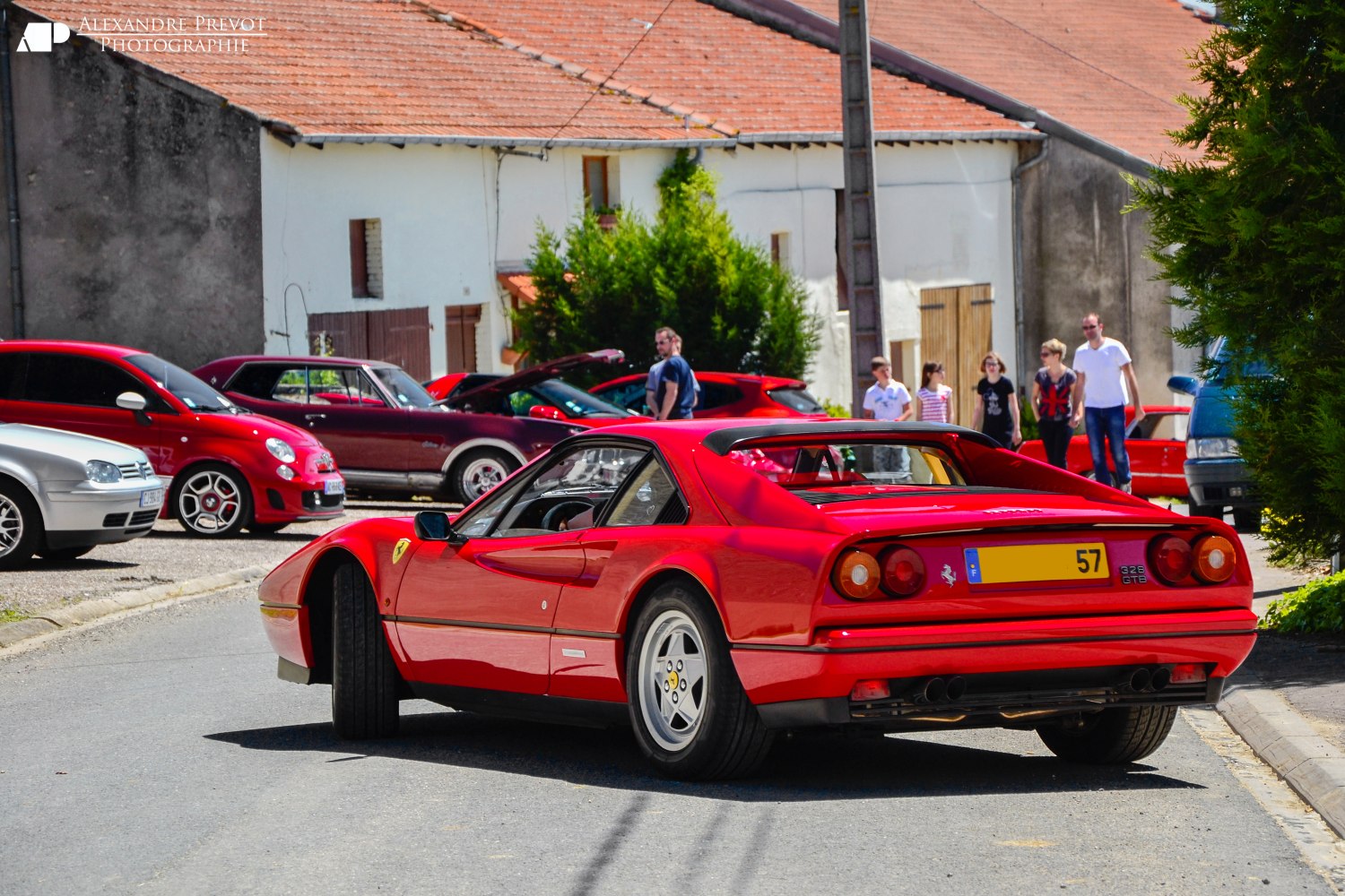 Rear side view of a red sports car with iconic taillights and sleek body lines