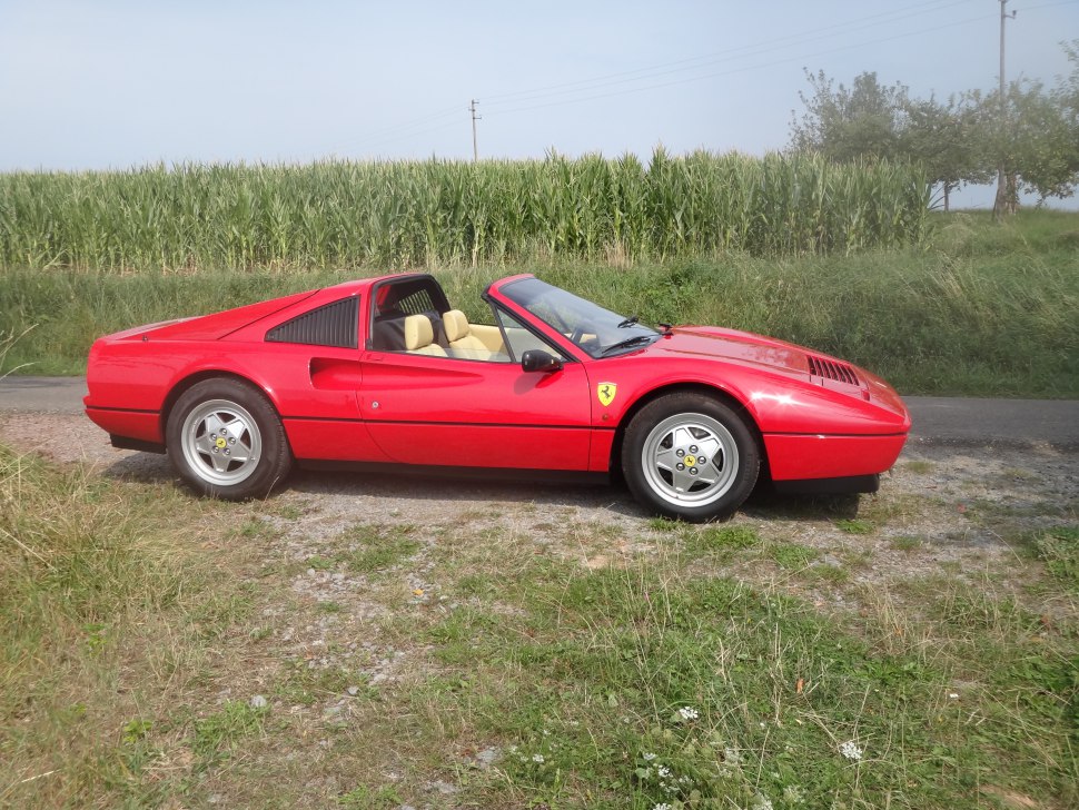 Red targa sports car with beige leather interior and alloy wheels