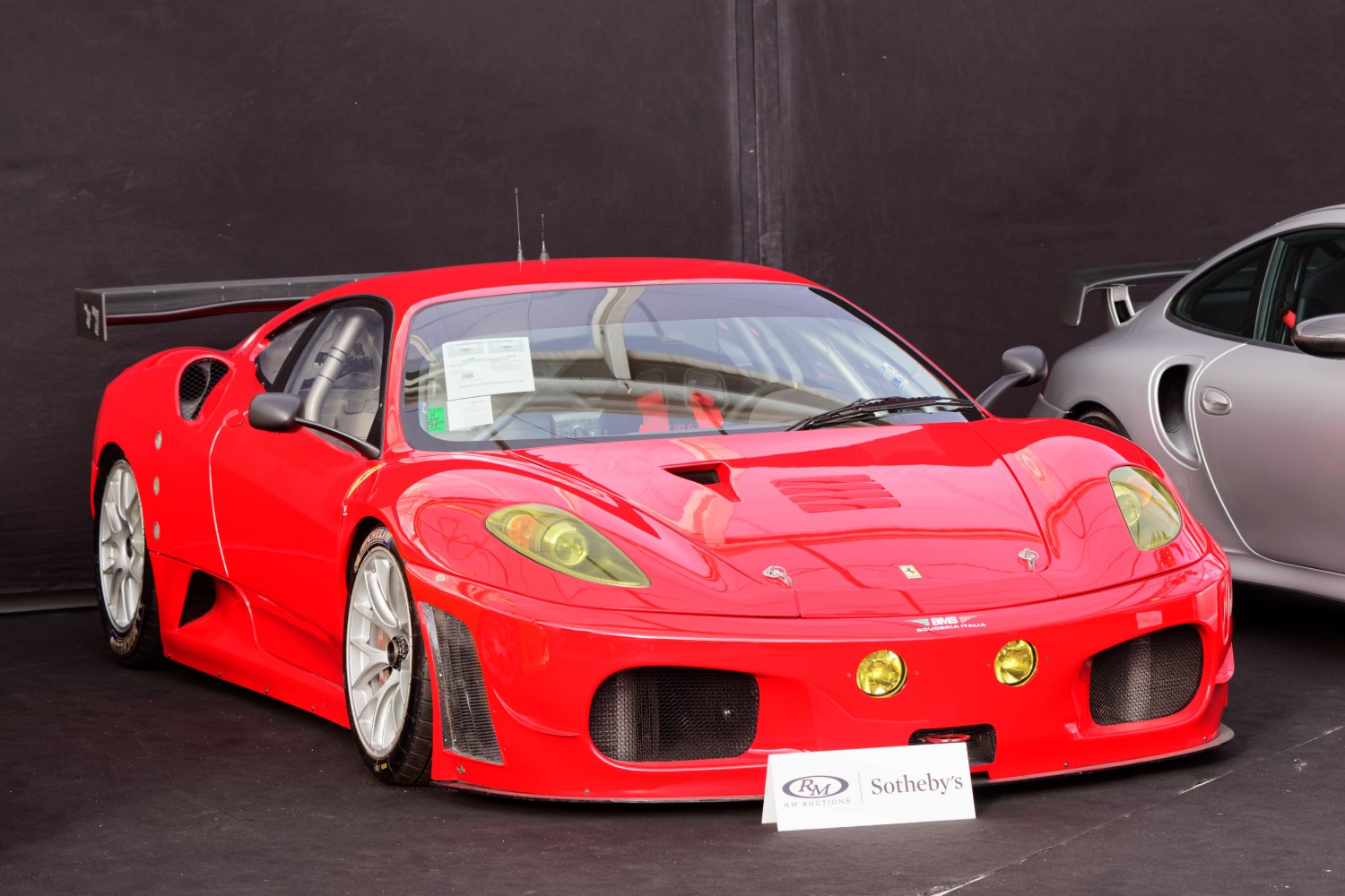 Racing car front view with yellow headlights and large rear wing