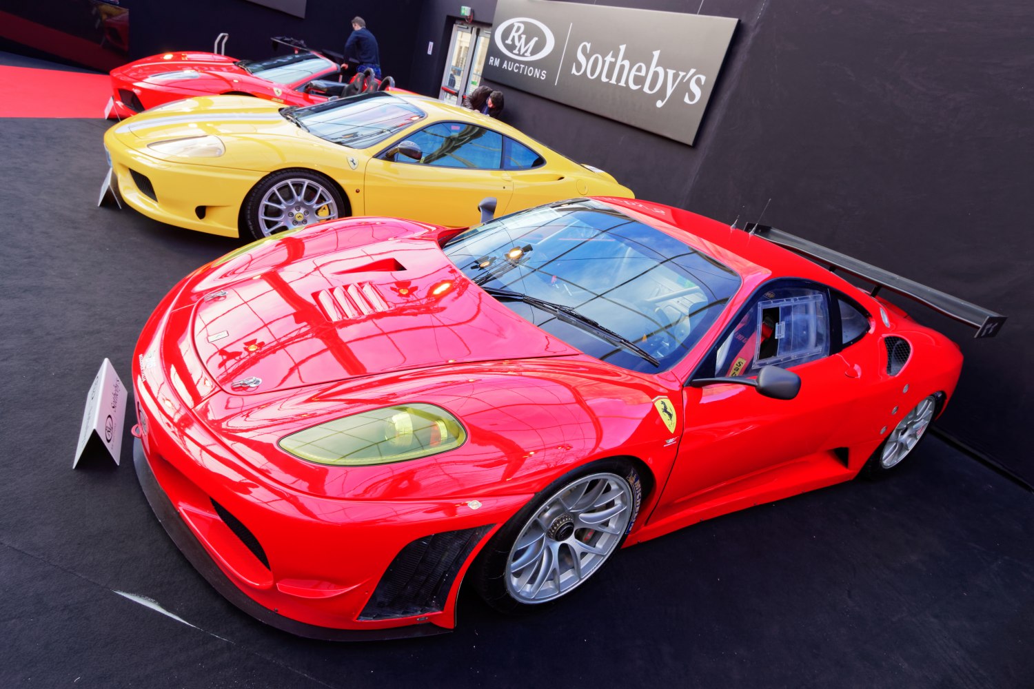 Aerodynamic Ferrari F430 GTC race car with large rear wing and detailed front view