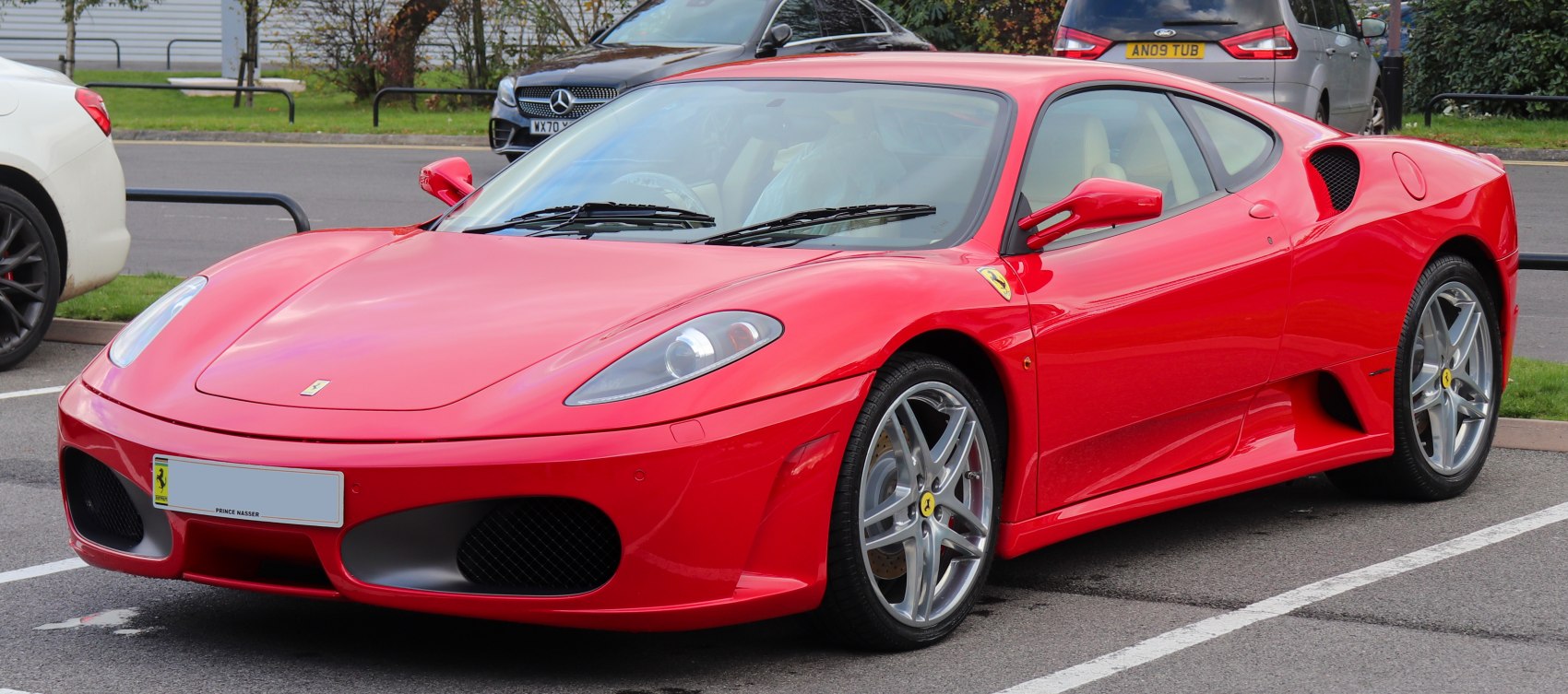 Red sports coupe with aerodynamic front and alloy wheels