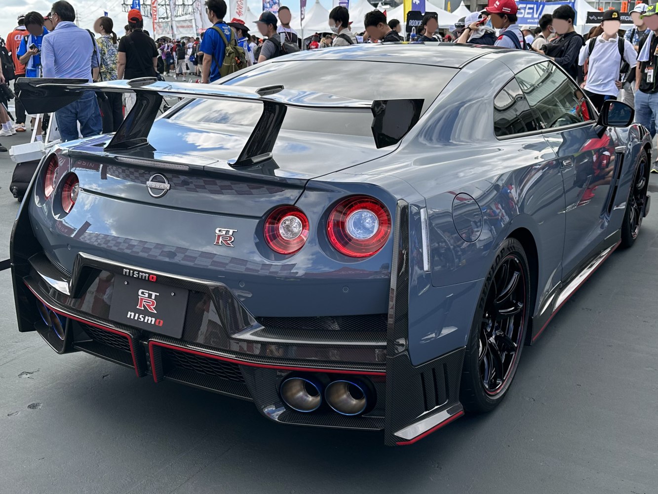 Rear view with spoiler, quad exhaust, and round tail lights
