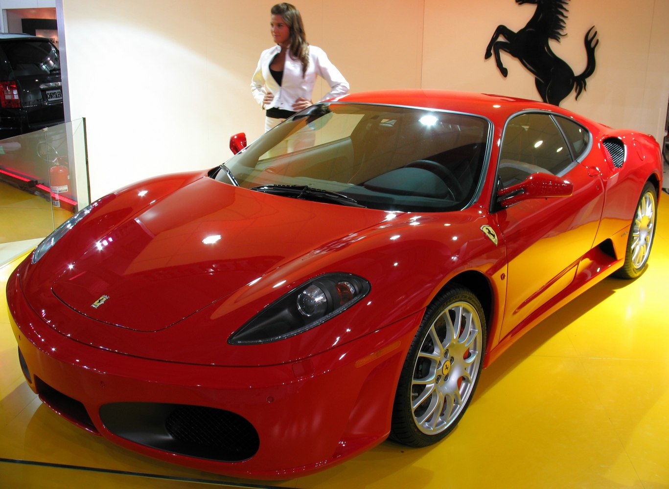 Red sports coupe with aerodynamic design and distinctive alloy wheels