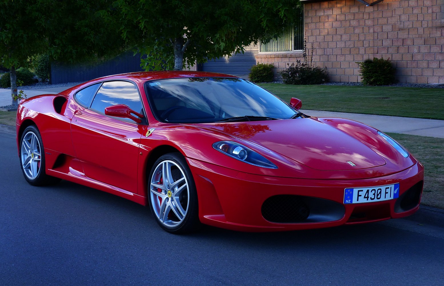 Red sports coupe with aerodynamic front and side profile.