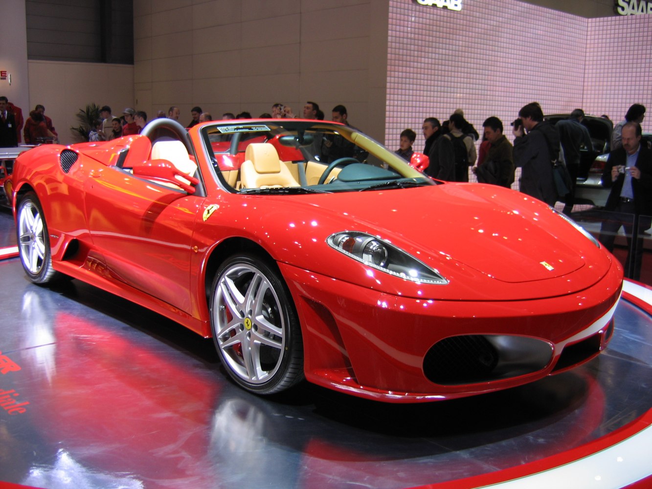 Red convertible with aerodynamic body and alloy wheels
