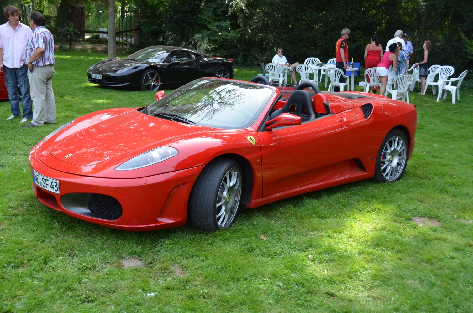 Red convertible sports car with open roof and aerodynamic design