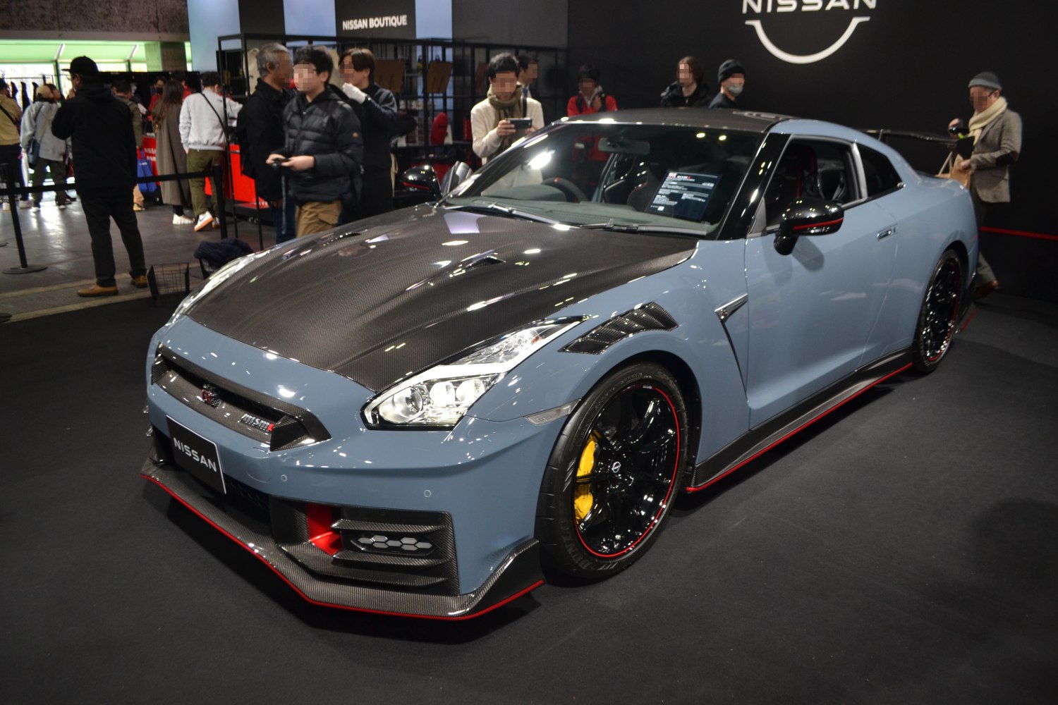Carbon fiber hood, aerodynamic accents, black wheels with red trim, yellow brake calipers