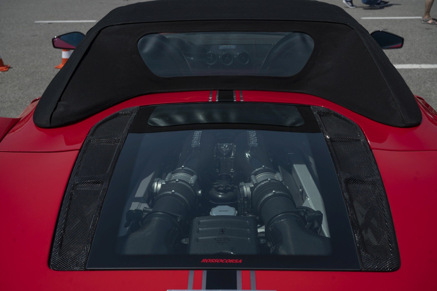 Mid-engine view with dual intake manifolds and racing stripe on convertible roof