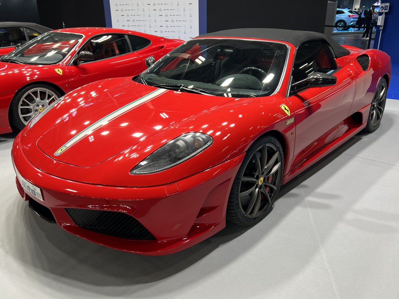 Red convertible sports car with sleek aerodynamic body and soft top roof