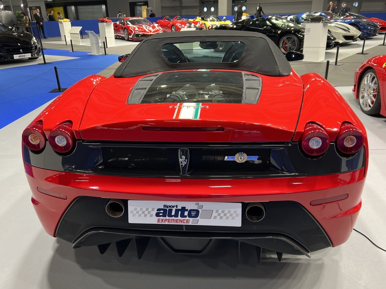 Rear view of red convertible with dual round tail lights and glass engine window