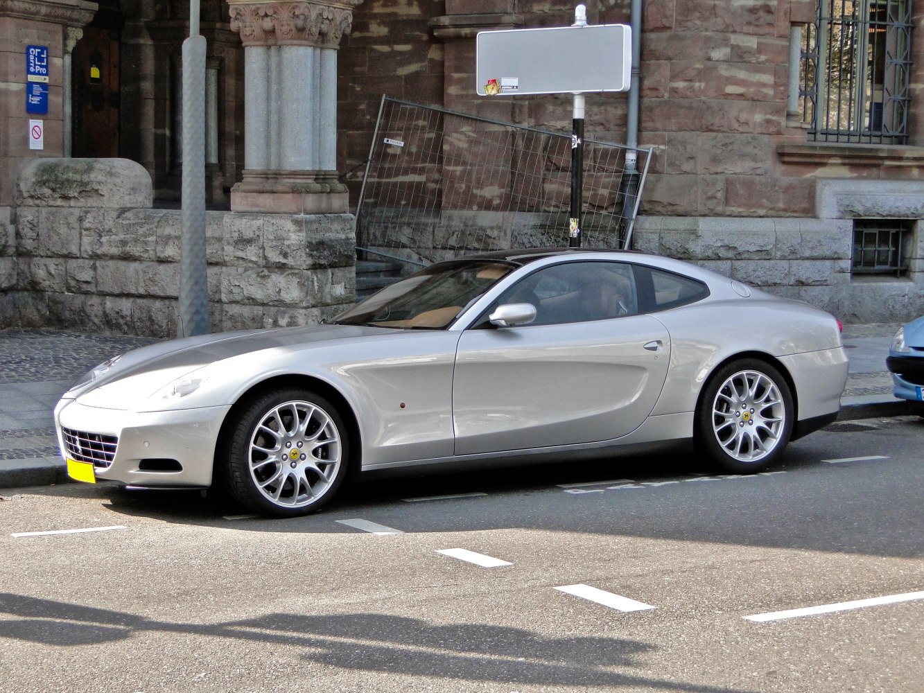 Silver 2-door sports coupe with alloy wheels and aerodynamic design