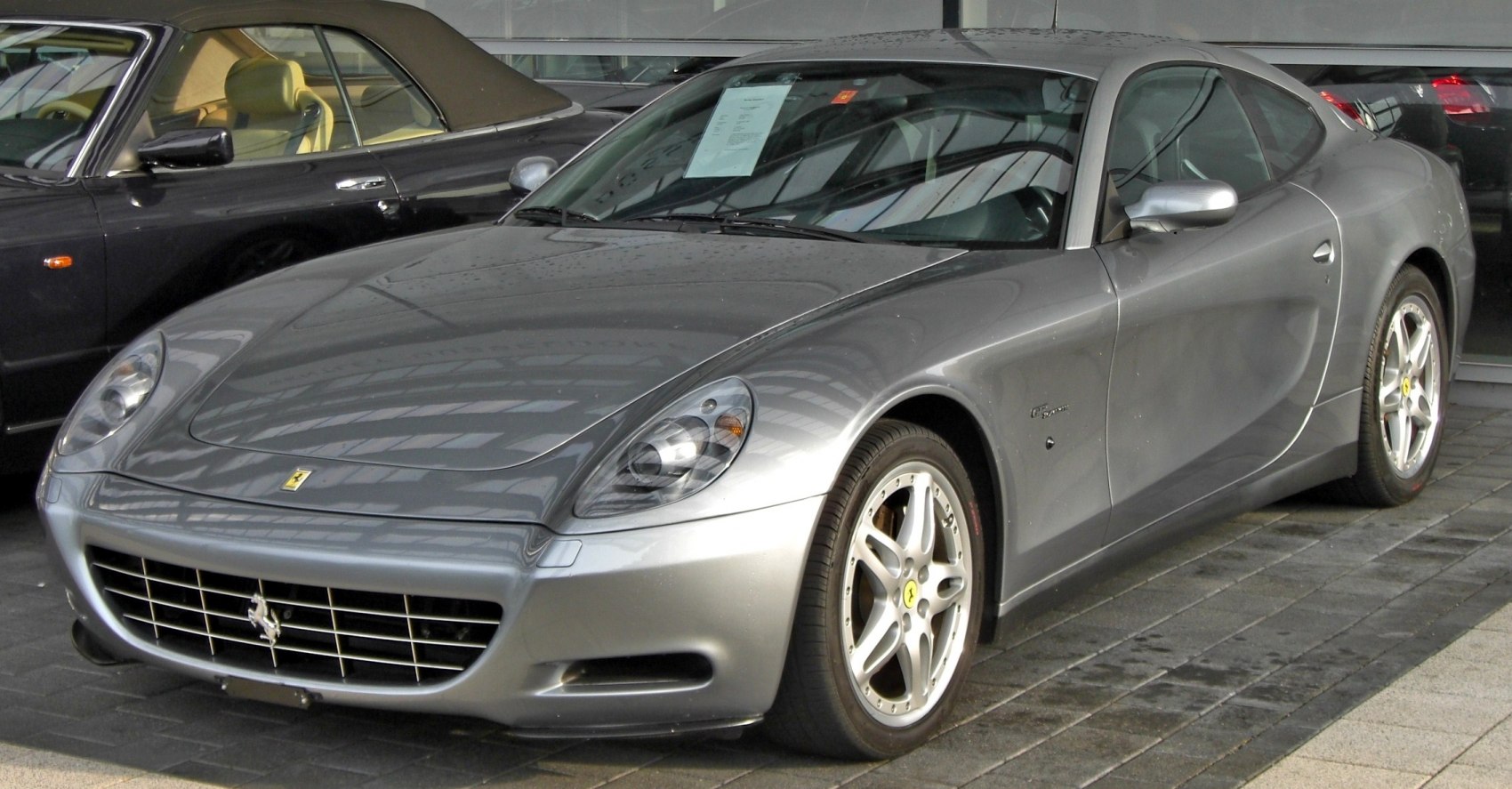 Smooth curved front and side design with distinctive headlights and alloy wheels