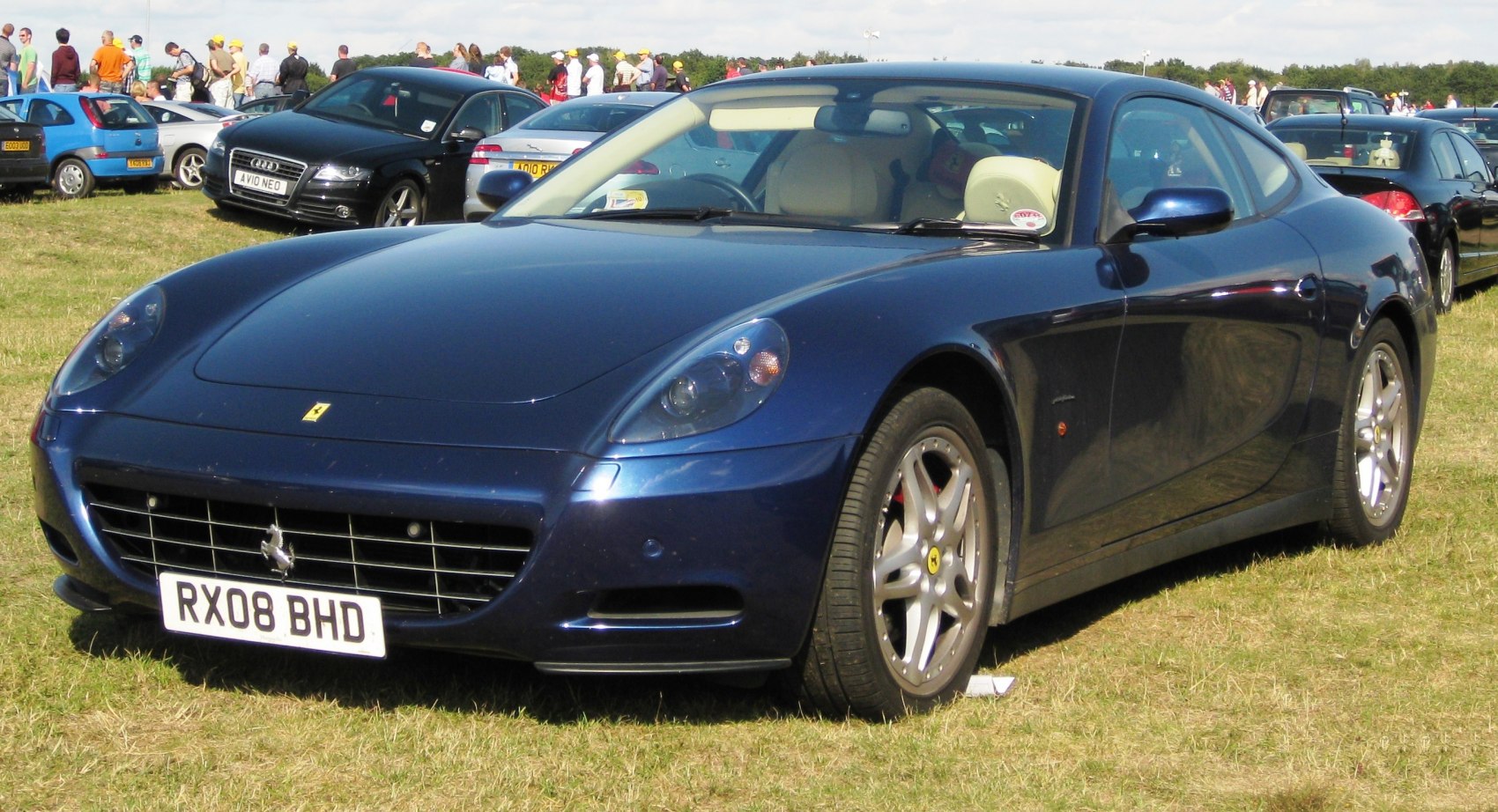 Front grille, headlights, and alloy wheels of a luxury coupe