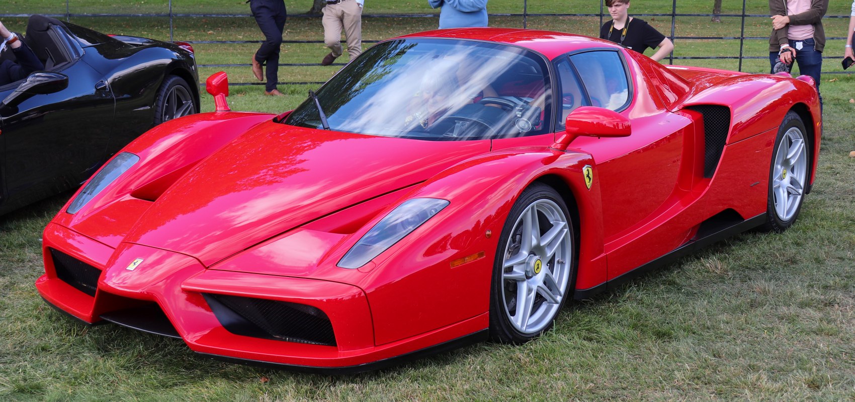 Sleek red sports car with aerodynamic front and side vents