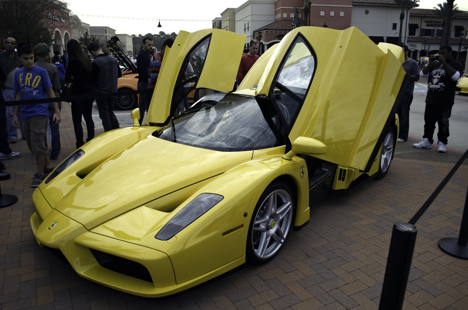 Yellow supercar with open scissor doors and aerodynamic front