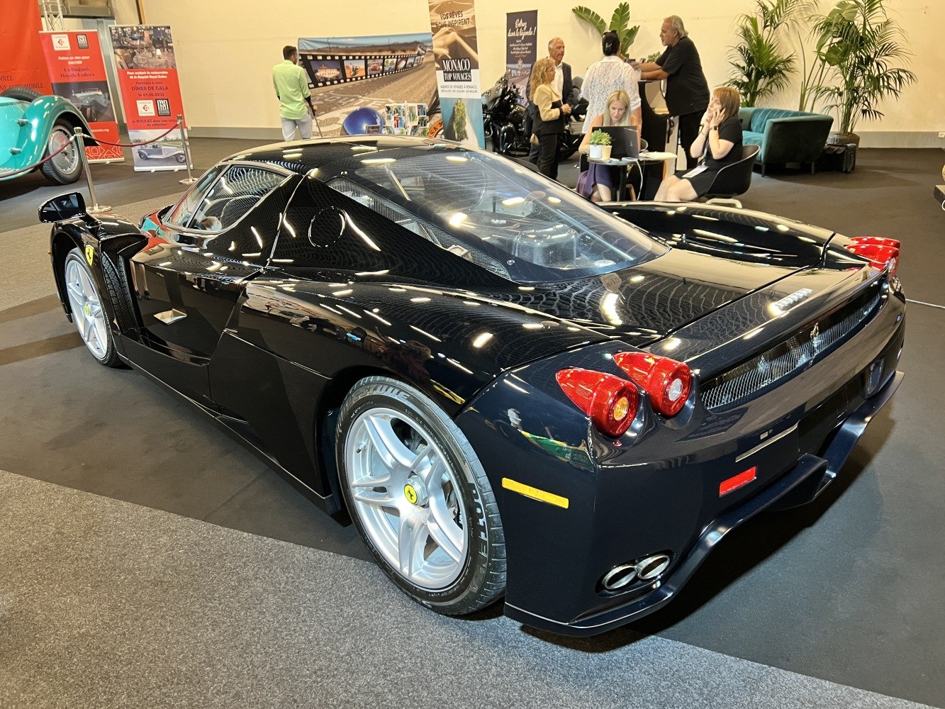 Rear view with transparent engine cover and quad exhaust on a sleek sports vehicle
