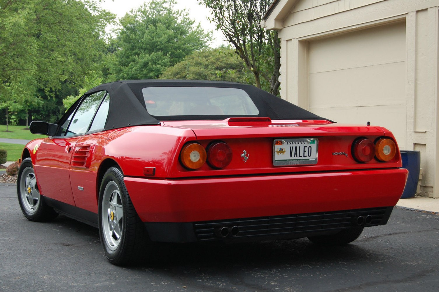 Rear view with round taillights and black soft top