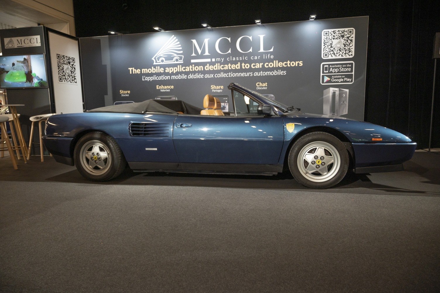 Side profile of blue cabriolet with alloy wheels and side air vents