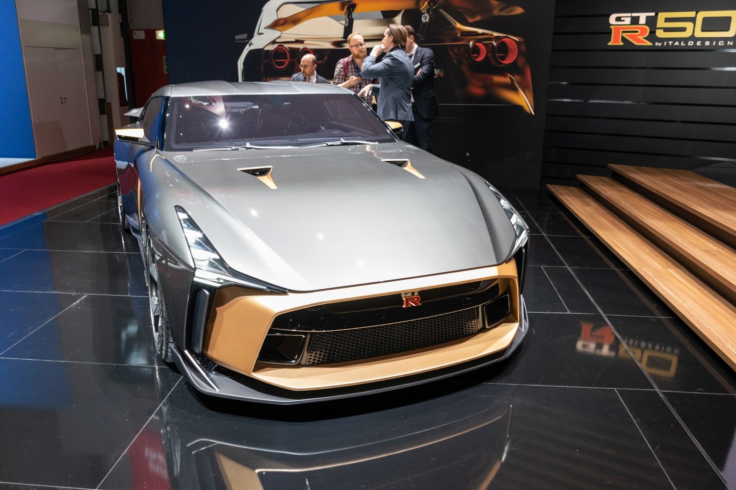 Futuristic sports car front with angular headlights and gold accents