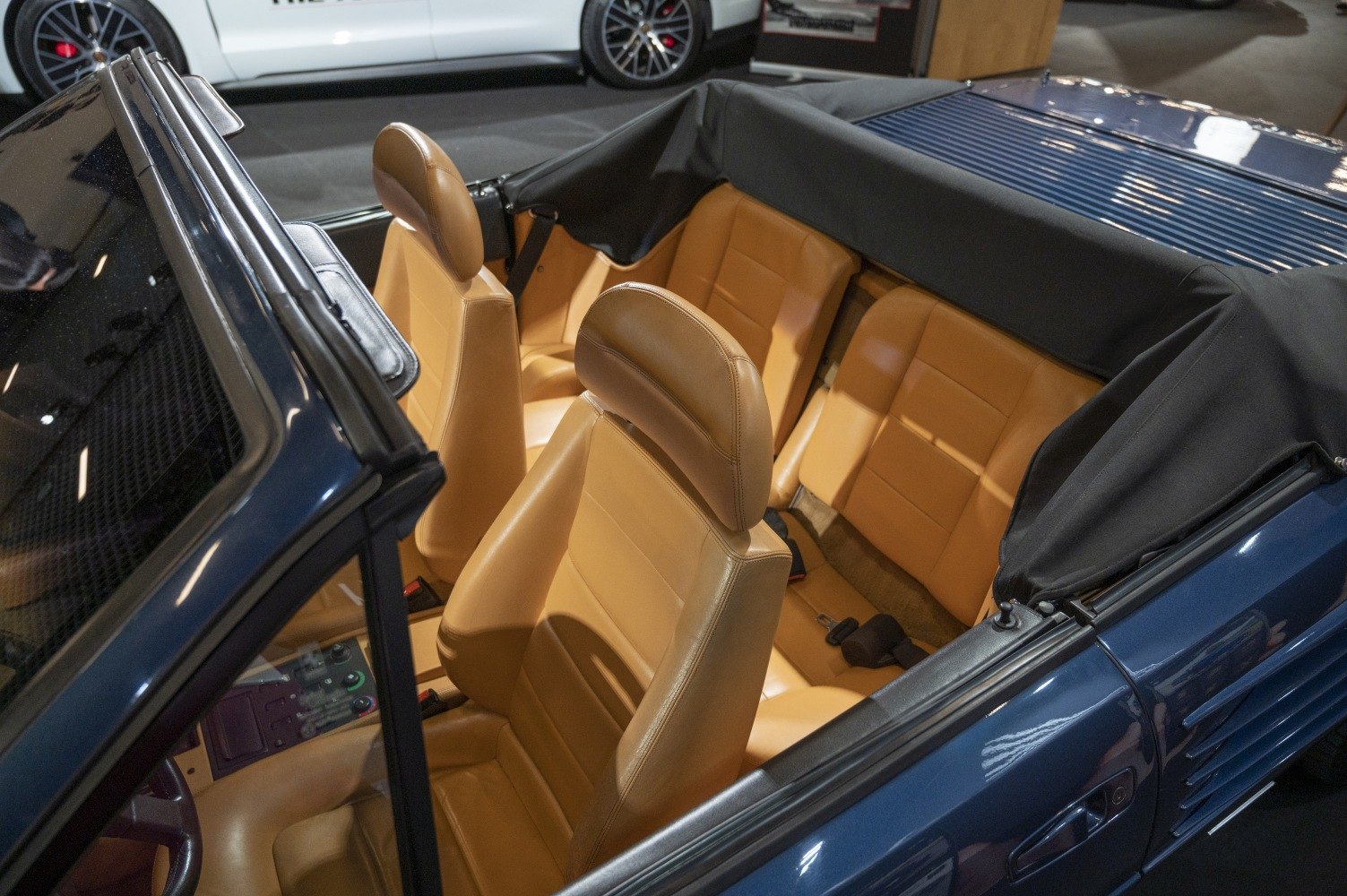 Tan leather seats and open convertible top interior