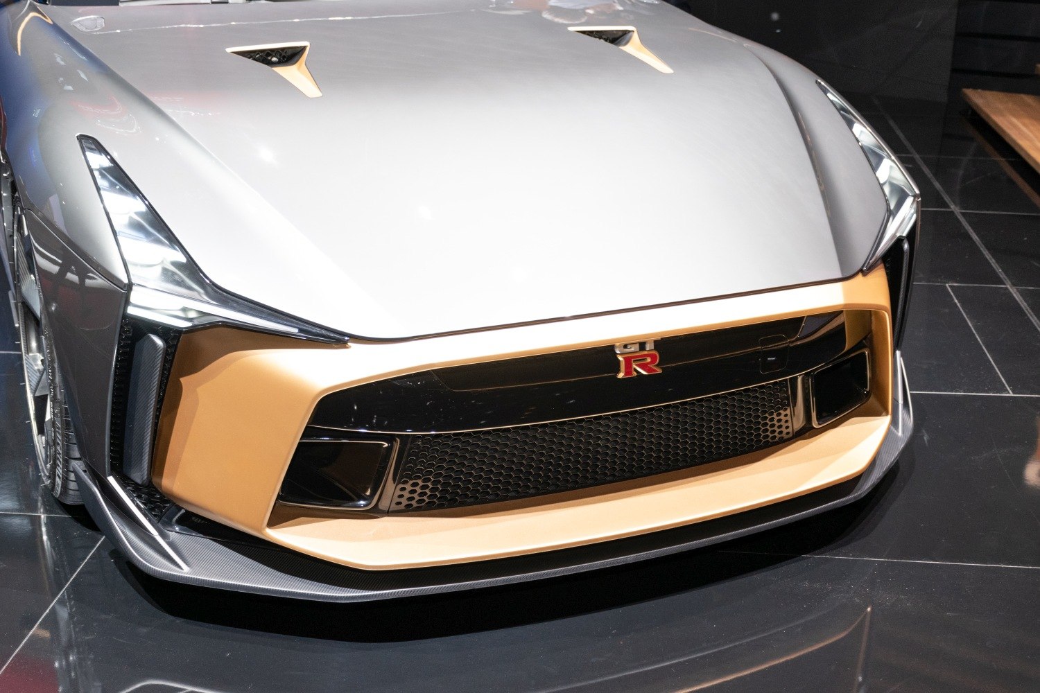 Sharp headlights and aerodynamic front splitter on a sleek front fascia