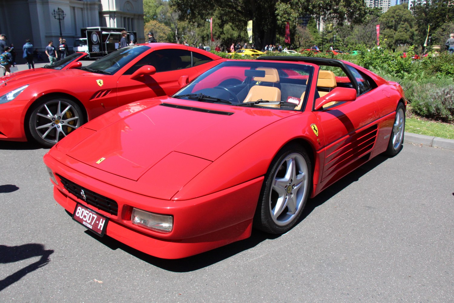 Red convertible with pop-up headlights and distinctive side strakes