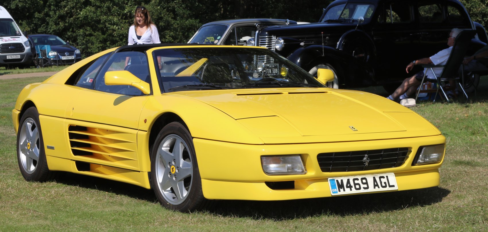 Yellow mid-engine convertible with distinctive side vents and pop-up headlights
