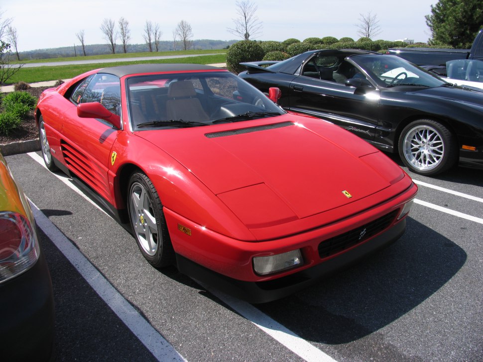 Red 1990 sports coupe with targa top and side strakes