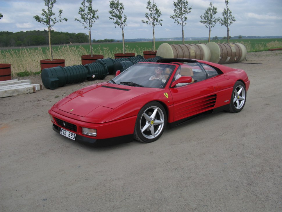 Red convertible sports car front side with alloy wheels