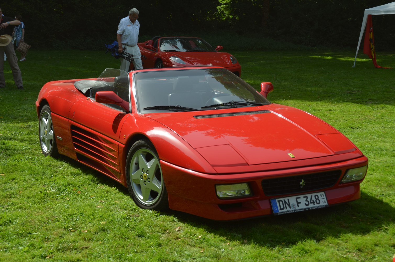Red convertible with aerodynamic side vents and five-spoke wheels