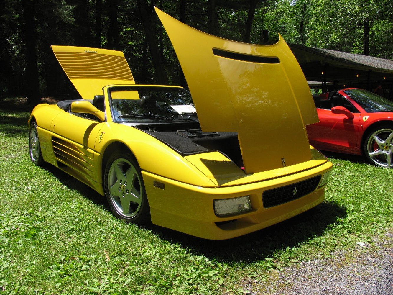 Yellow convertible with open front and rear hoods