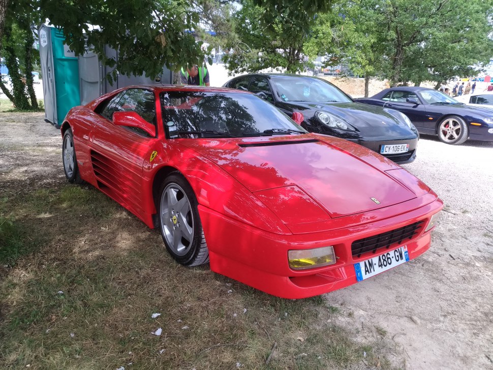 1990 red sports coupe with pop-up headlights and side air strakes