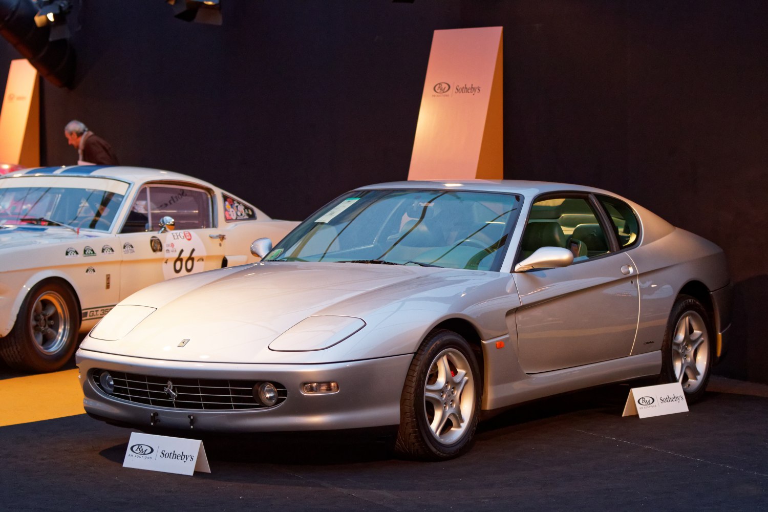 Silver two-door sports coupe with pop-up headlights and aerodynamic shape