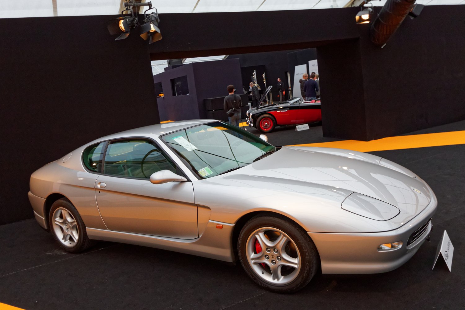 Silver coupe with pop-up headlights and five-spoke alloy wheels