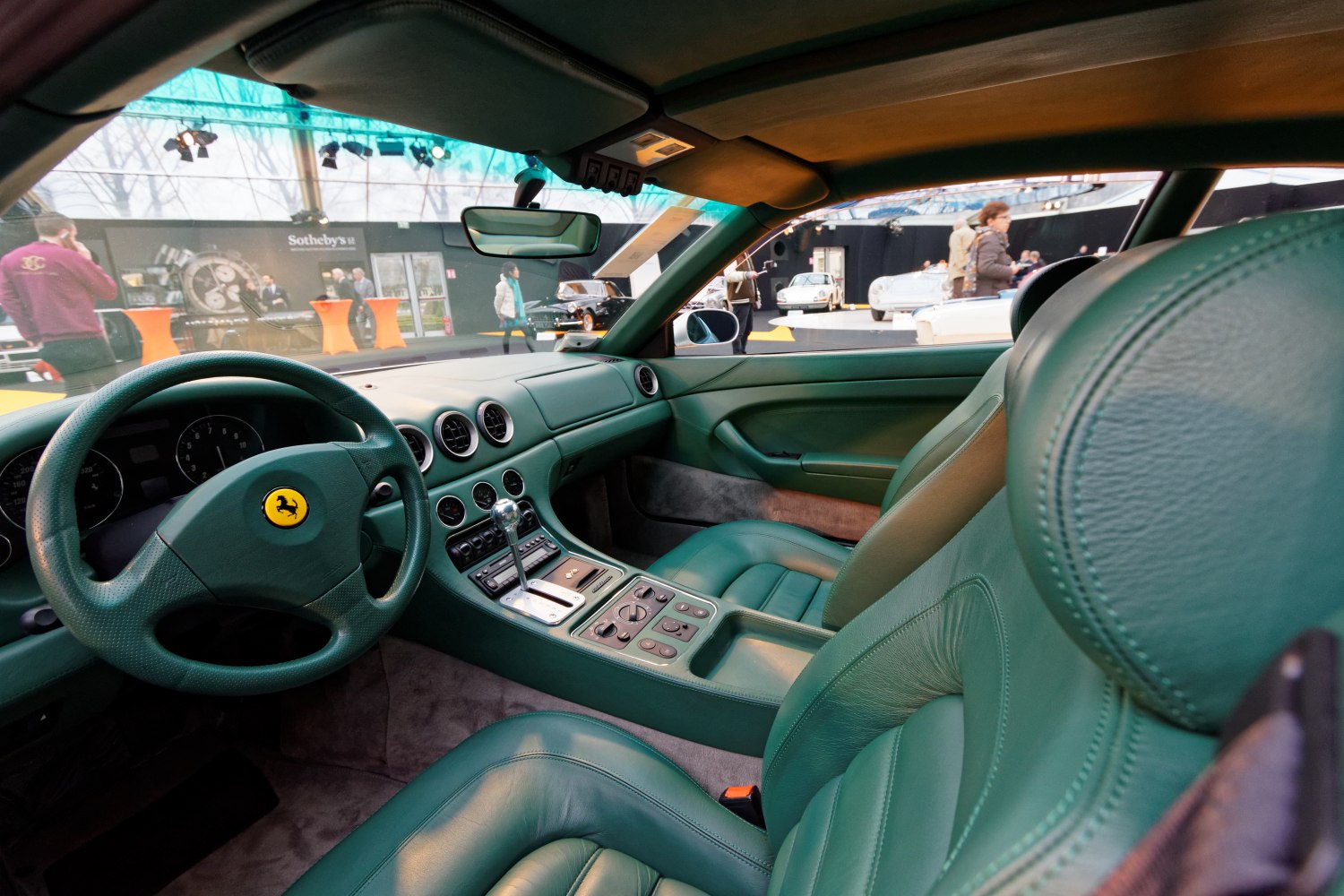 Green leather interior with classic dashboard and gear shift
