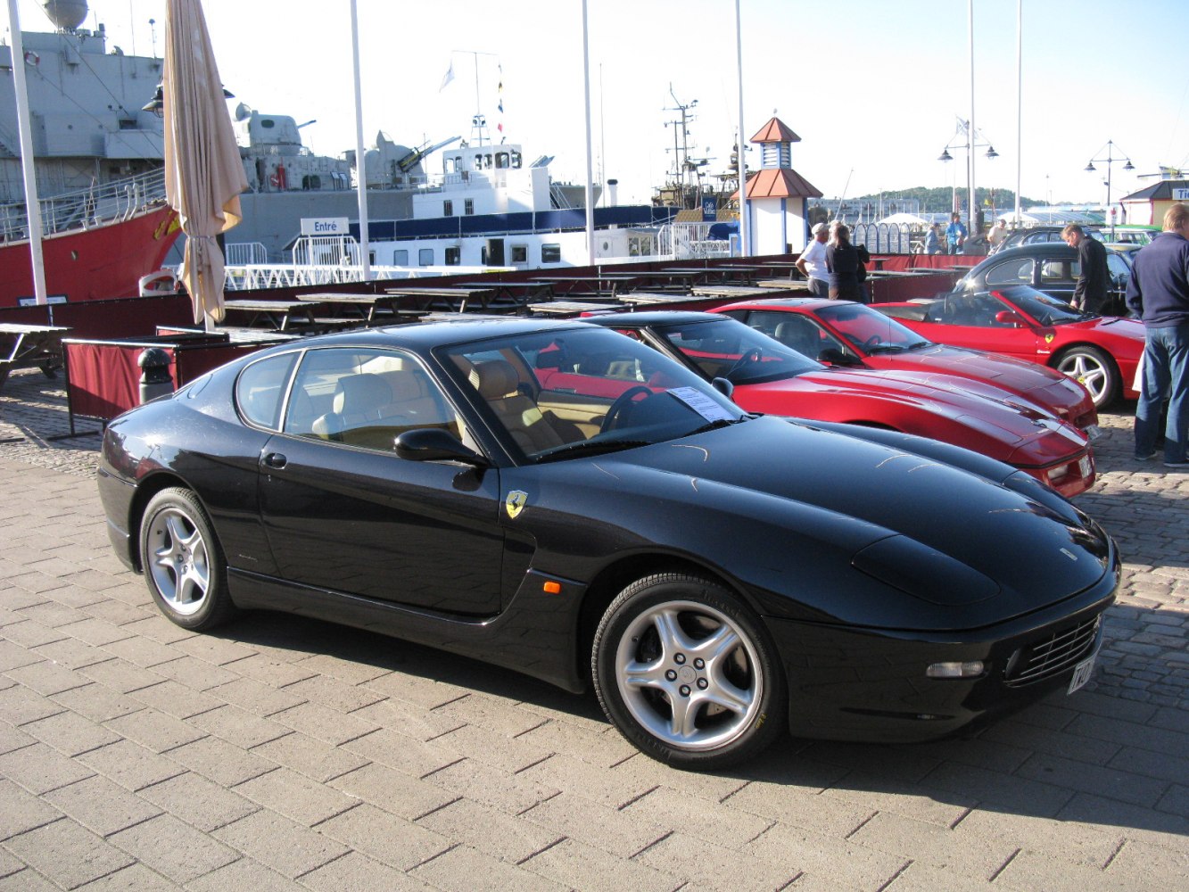 Black sports coupe with five-spoke alloy wheels and aerodynamic design.