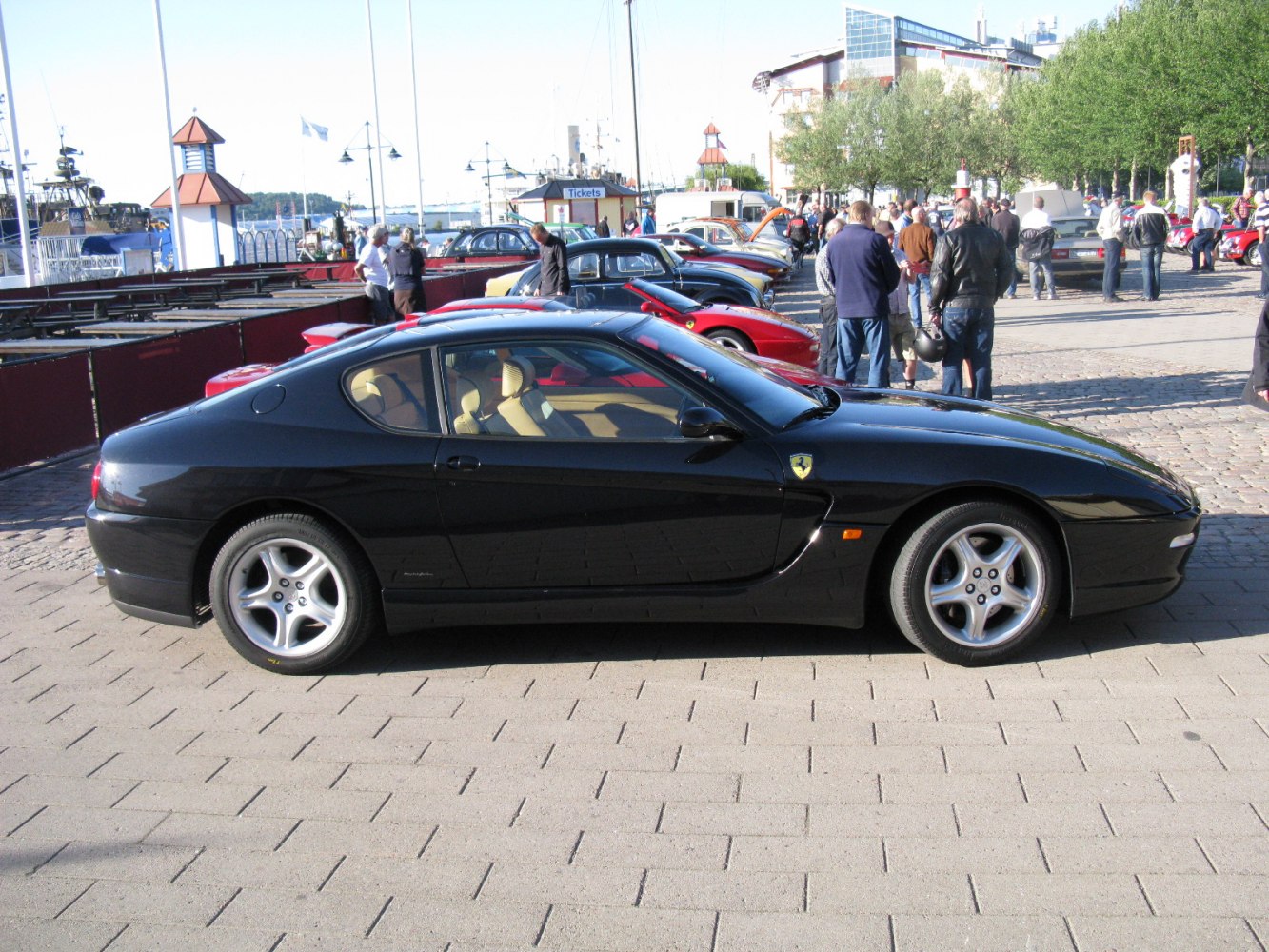 Side view of a sleek black coupe with five-spoke alloy wheels
