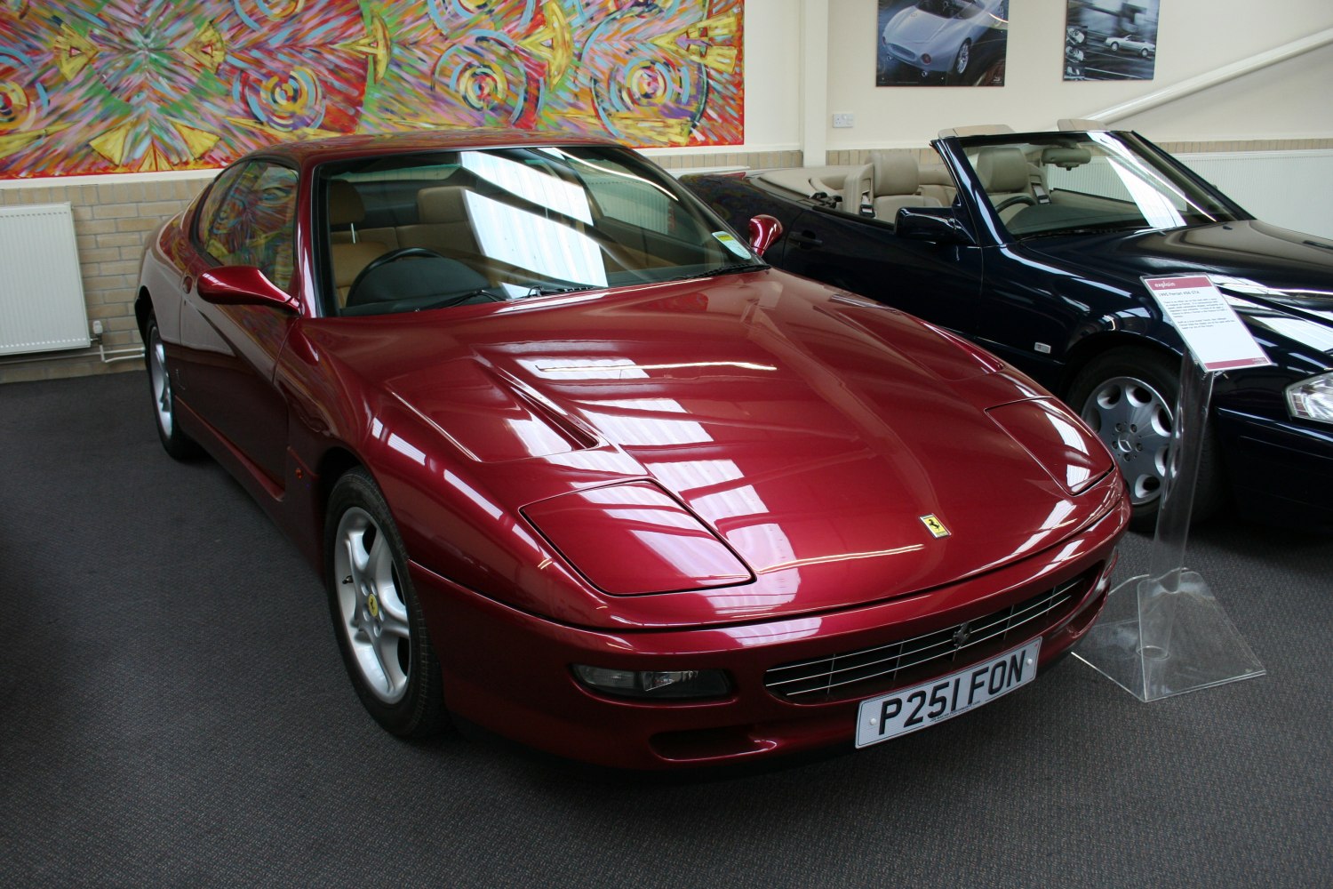 Red sports coupe with pop-up headlights and a distinctive front grille