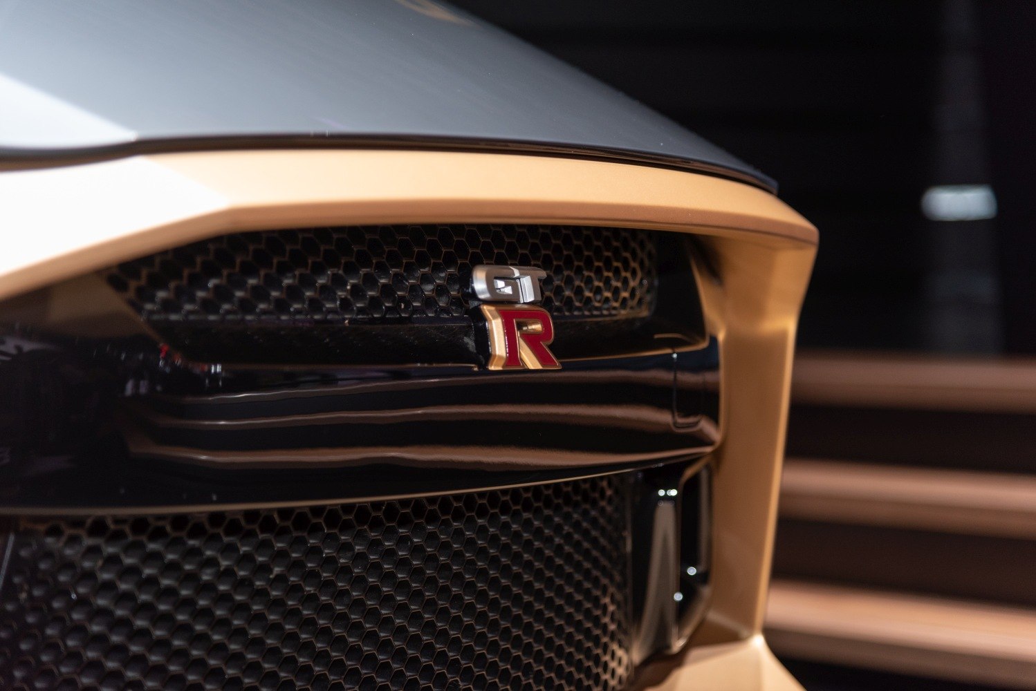 Close-up of front grille with GT-R emblem and honeycomb mesh pattern