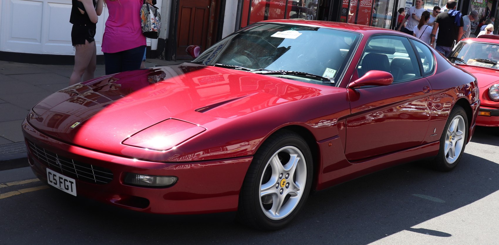 Bright red sports coupe with pop-up headlights and alloy wheels.