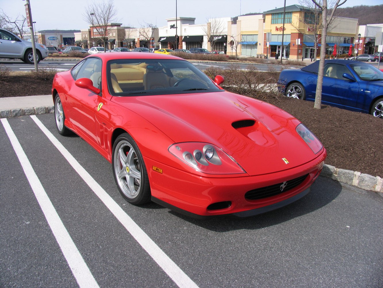 Red sports car with hood air scoop and sleek multi-lens headlights