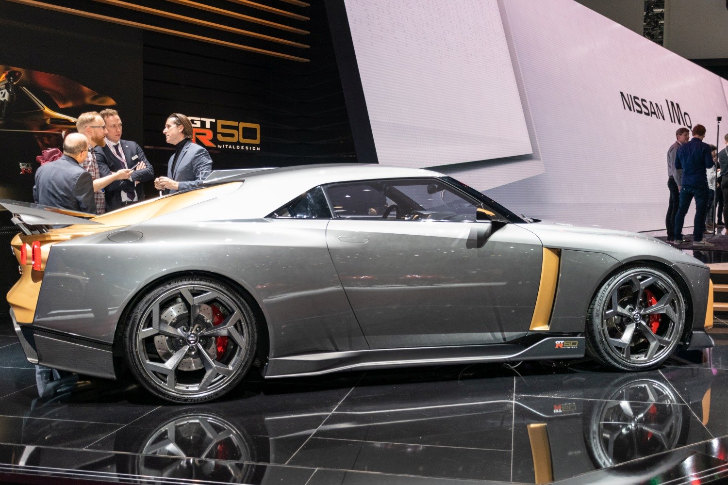 Side profile of a sleek sports coupe with gold accents and sporty wheels