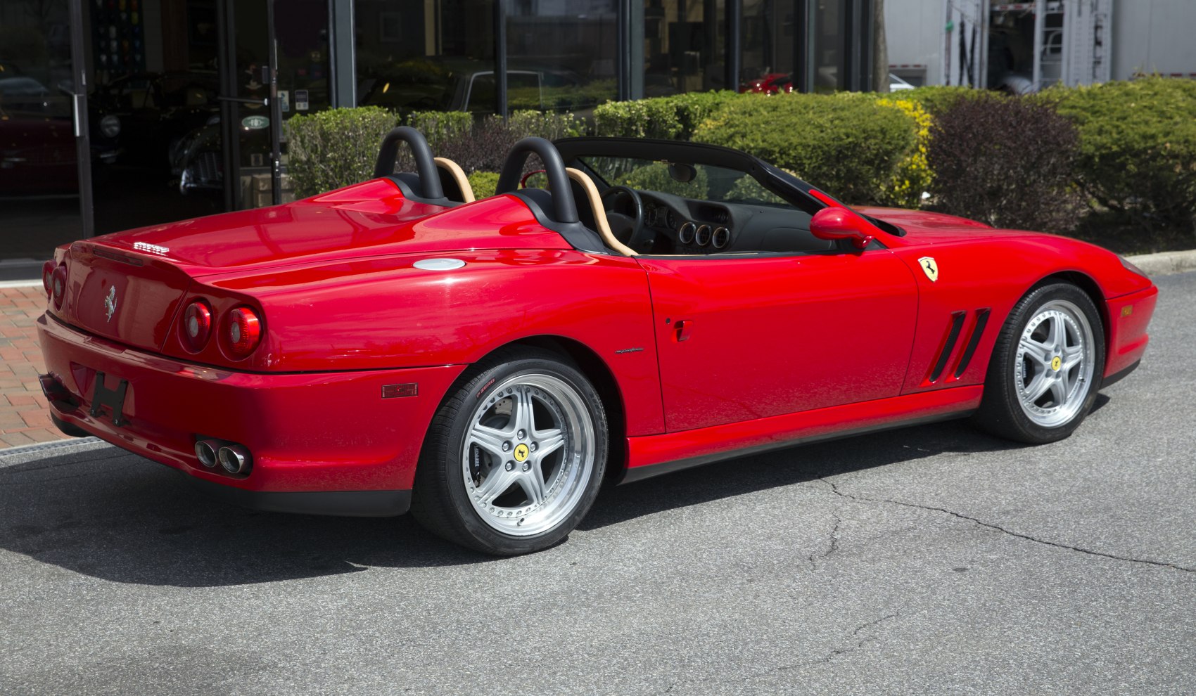 Red convertible with roll bars and five-spoke alloy wheels