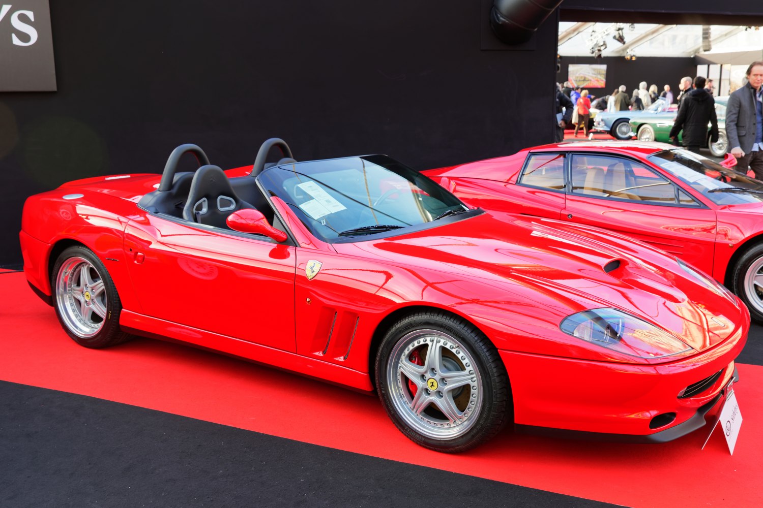Red convertible with open-top design and sporty two-seater layout