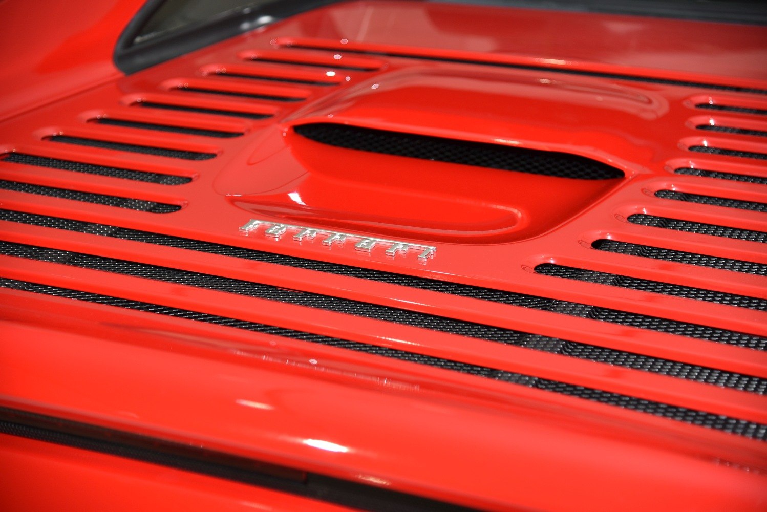 Red rear engine cover with vents and Ferrari emblem