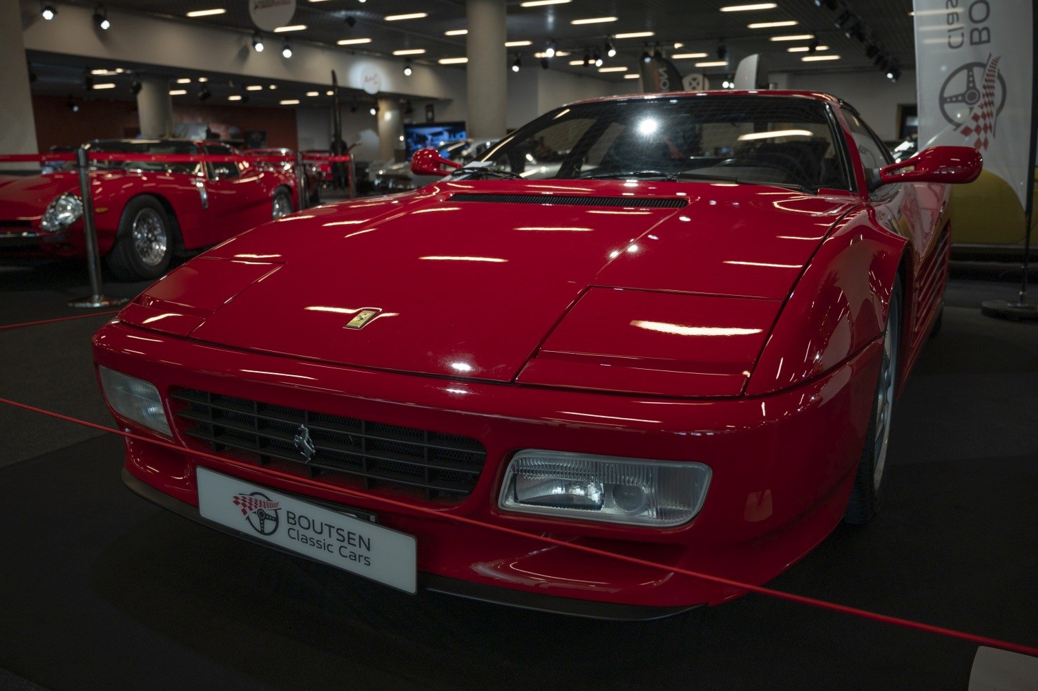 Front view of red sports car with flip-up headlights and grille