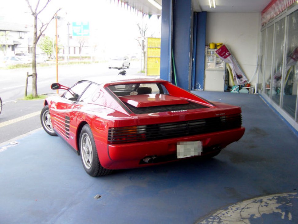 Rear view of classic 1980s sports coupe with horizontal grille and side vent stripes