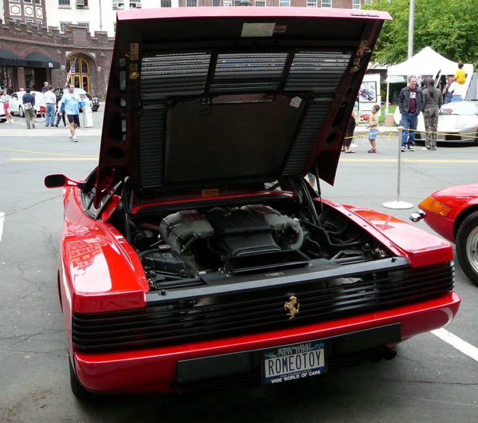 Rear engine compartment with open hood showcasing mid-engine layout