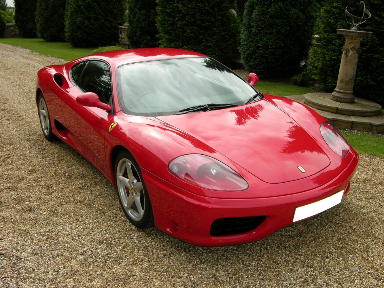 Front angle view of a red sports car with sleek design and headlights.